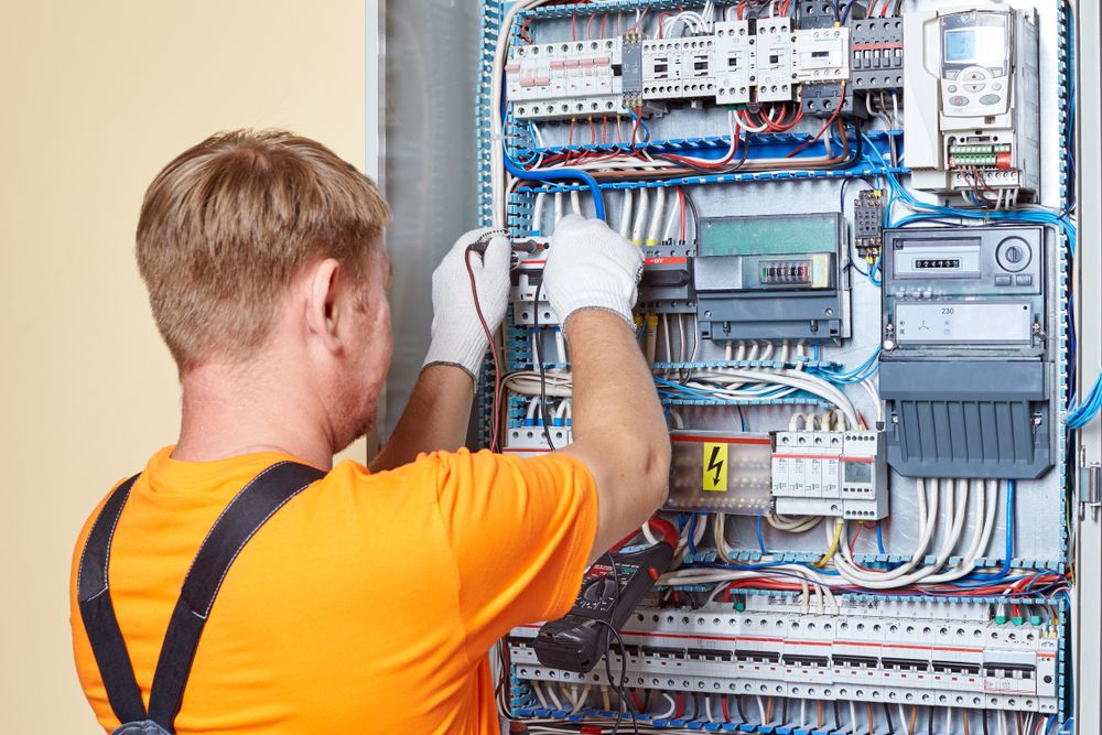 Electrician working on an electrical panel