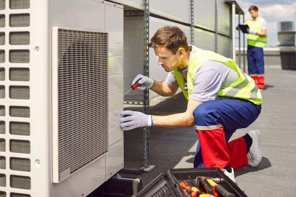 HVAC technician servicing an air conditioning unit